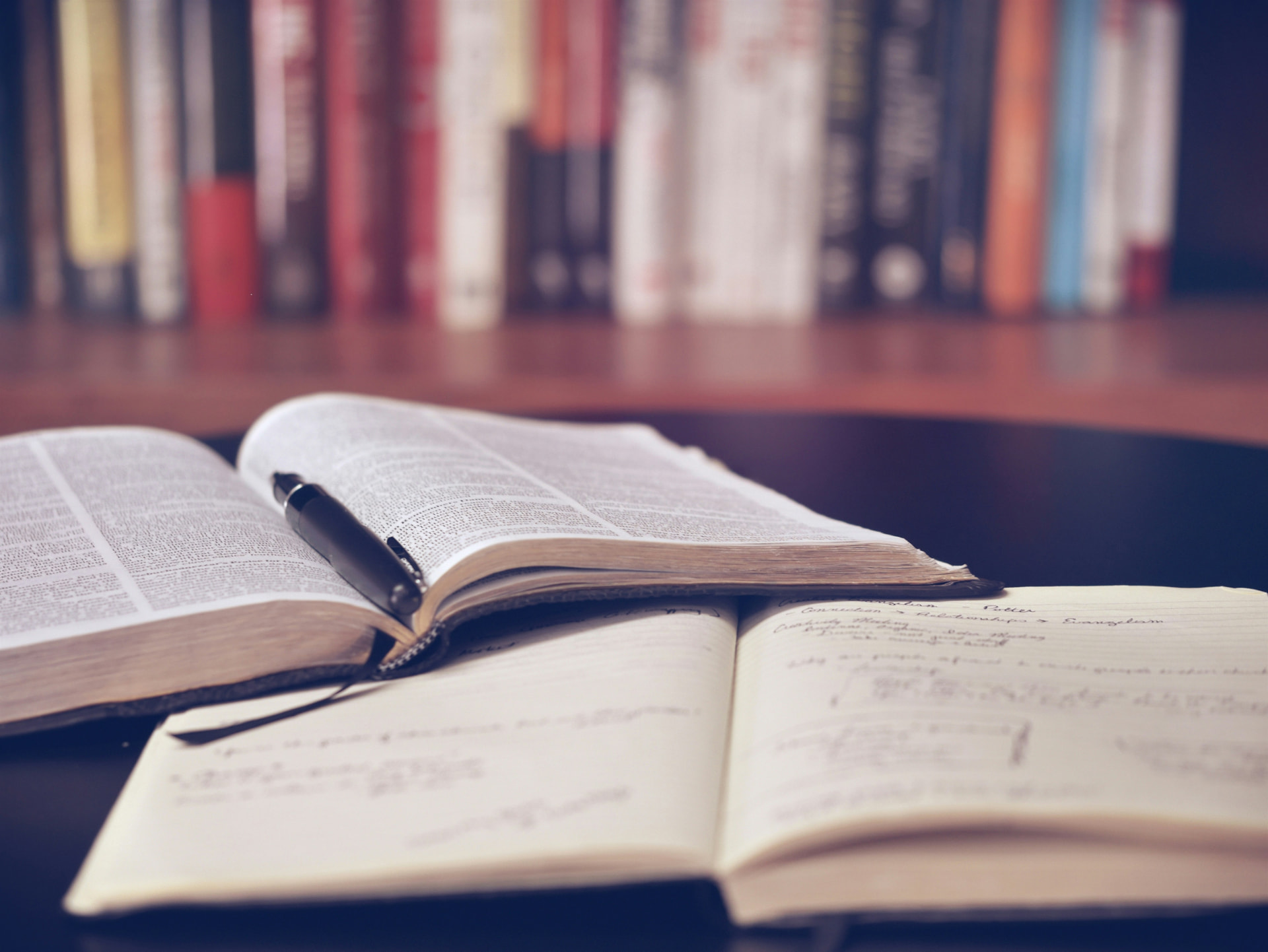An open reference book and handwritten notes